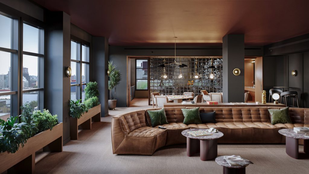 Game room at 499 President St rental apartments with shuffleboard, pool table, and seating area with small tables.