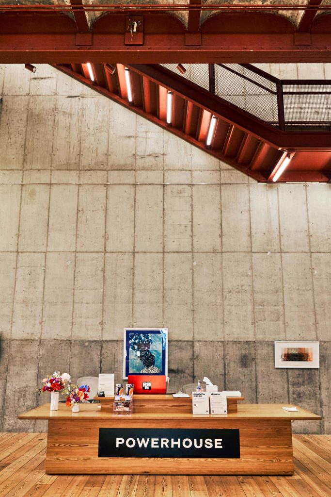 Lobby and front desk at Powerhouse Art gallery in Brooklyn designed by Herzog & de Meuron architects.